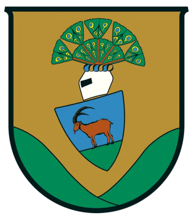 Zu sehen ist das Wappen der Gemeinde Thalgau. 2 Hänge symbolisieren das Tal, weiters ein Steinbock und ein geschmückter Helm.